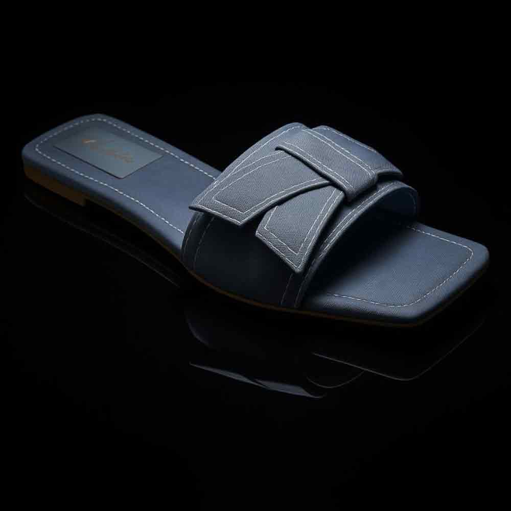 Blue slide sandal with a strap on a black background